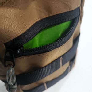 Open zipper pocket on the front of a fly fishing pack.