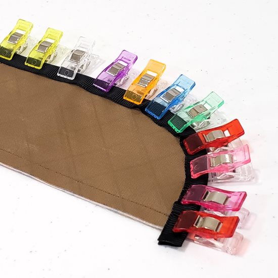 Grosgrain ribbon clipped to a project panel, ready to be sewn in.